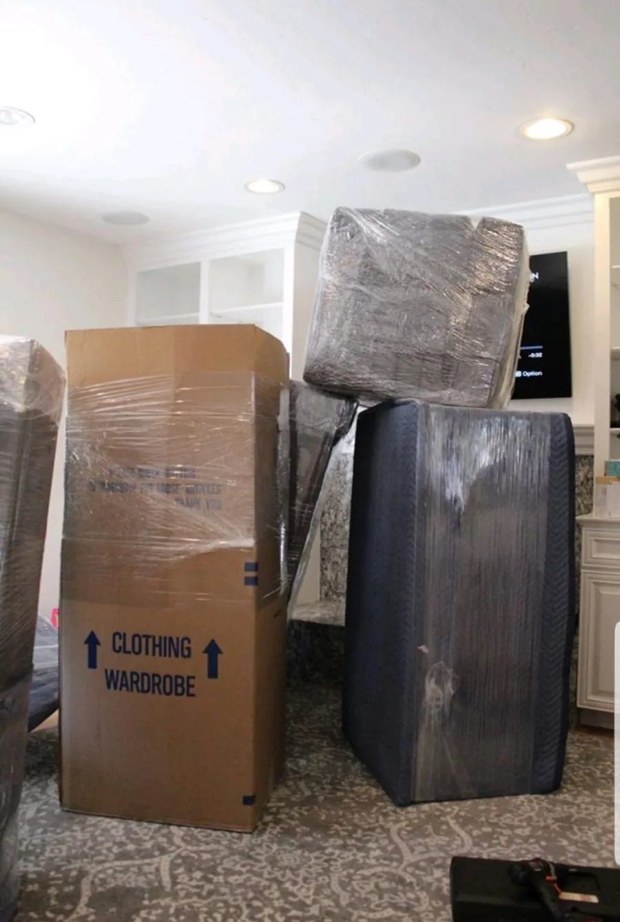 Wrapped furniture and wardrobe boxes organized for a move